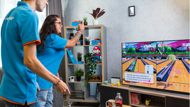 Junge und Mädchen spielen Mario Kart auf Nintendo Switch.