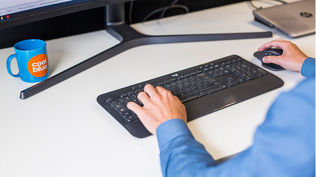 Man works with mouse and keyboard.