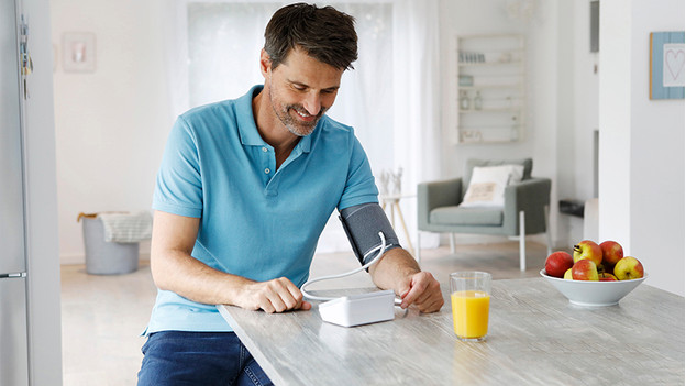 Man with blood pressure monitor