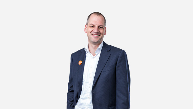 Happy businessman with Coolblue badge on jacket.