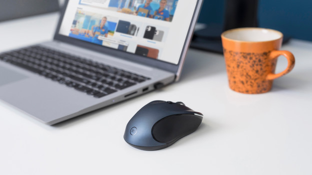 Silent mouse on desk next to laptop