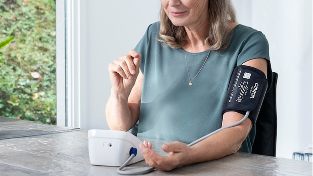 Woman with blood pressure monitor