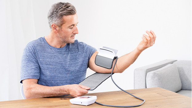 Woman with blood pressure monitor