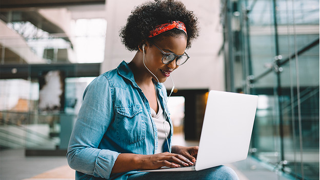 Woman works on a laptop.