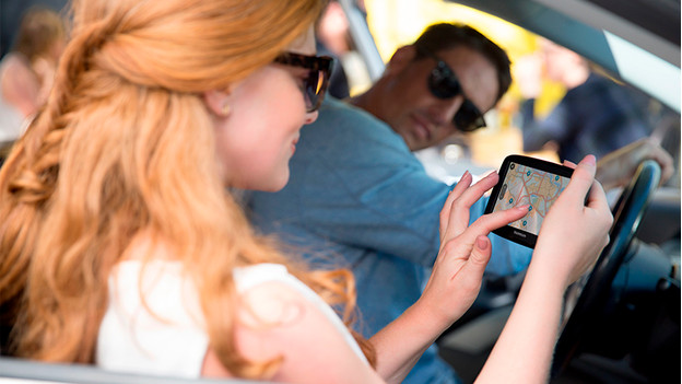 Man and woman with navigation system in car