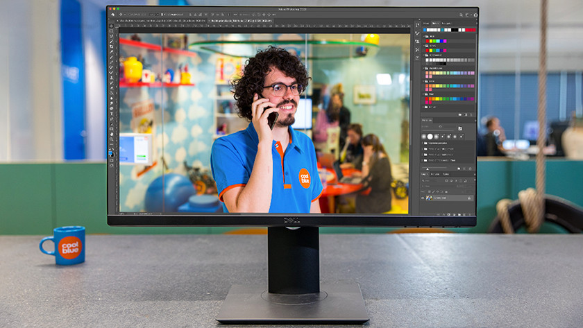 Photo of an expert on a photo editing monitor