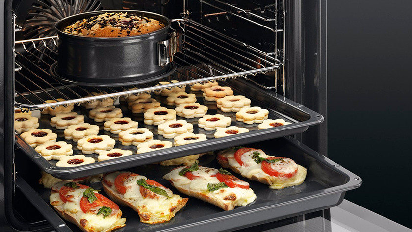 Oven with cake, cookies, and paninis