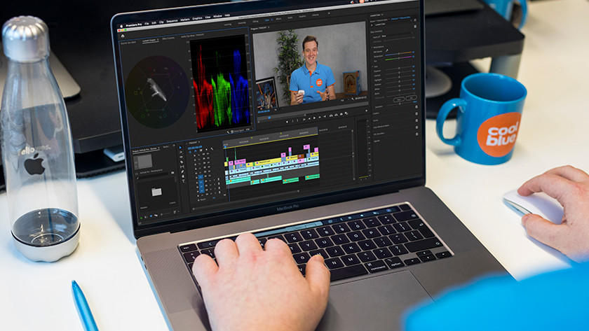 Expert edits video in Adobe Premiere Pro on a 16-inch laptop