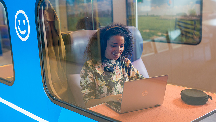 Woman working on a laptop in the train.