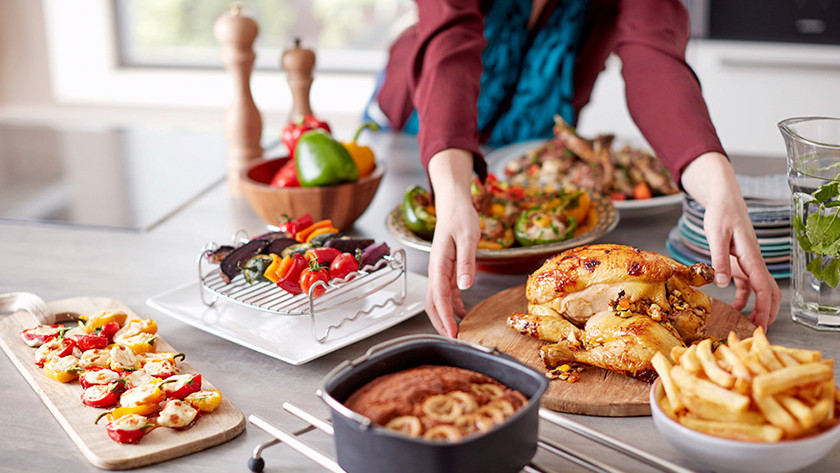 Chicken, fries, pie, and grilled vegetables on the counter