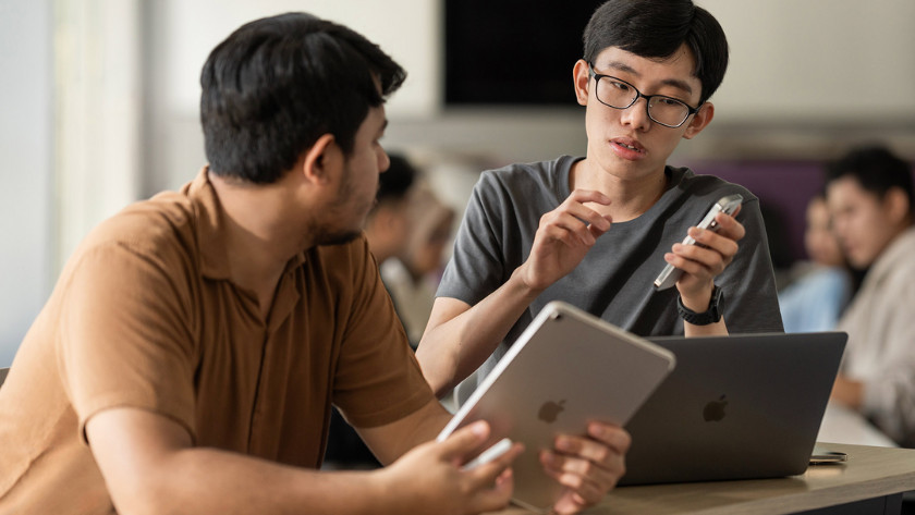 Students using MacBook, iPad, and iPhone