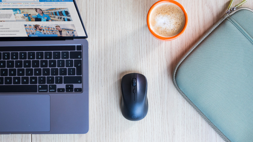 Nexum mouse on a desk with laptop