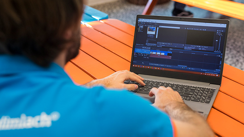 Man edits videos on laptop.