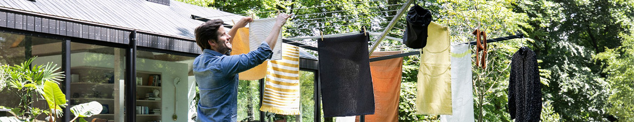 How do you place the ground anchor of your umbrella drying rack?