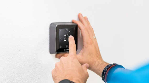 Smart thermostat on a wall