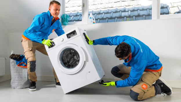Adjust leg stands of a washer dryer combination.