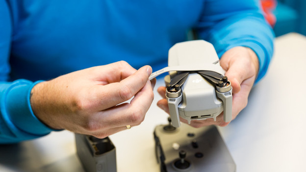 Nimm den Gurt von der Drohne ab