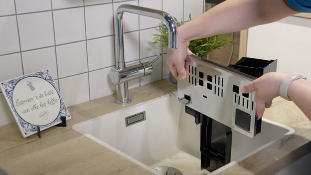 Empty the coffee grounds container and drip tray