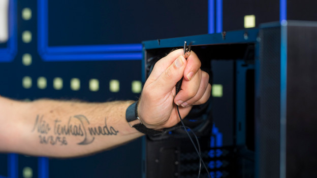 Expert grounds himself via an antistatic wrist strap