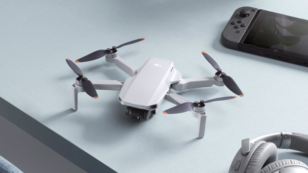 Drone on table next to other consumer electronics.