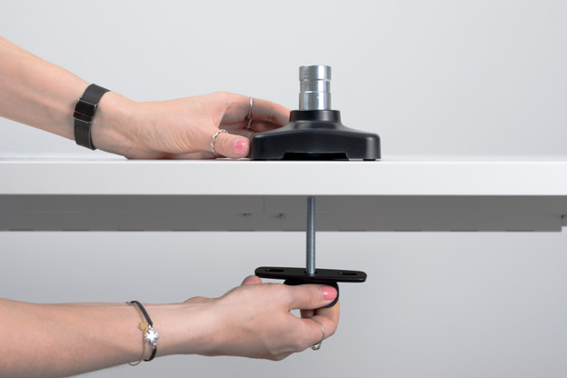 Install the monitor base in the desk