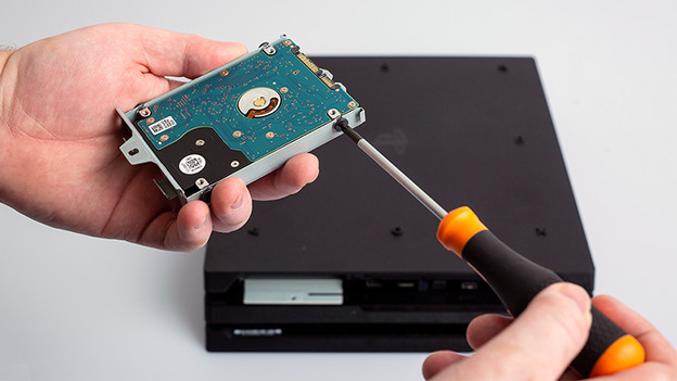 Unscrewing PS4 Slim HDD bracket