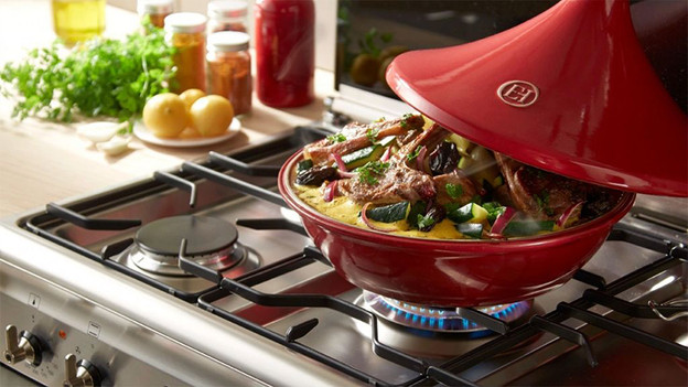 Tajine on gas stove with ingredients