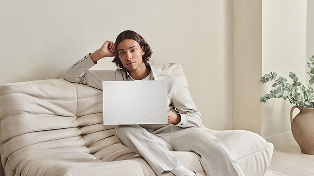 Junge arbeitet auf der Couch.