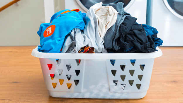 Full laundry basket with wet laundry.