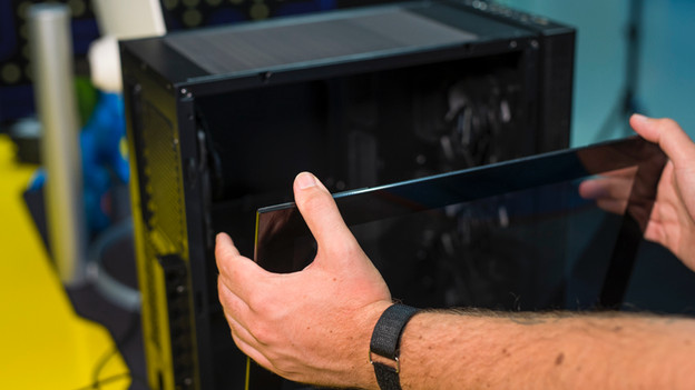 Expert opens the case to remove the motherboard