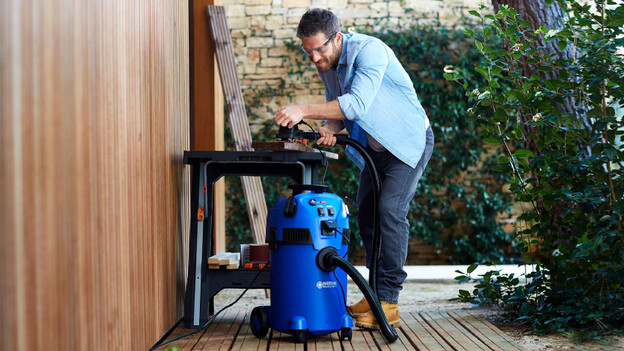 Person uses tools connect to the construction vacuum