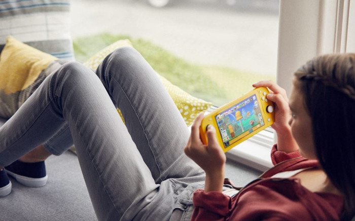 Nintendo Switch Lite + Tomodachi Life: Living the Dream product in use